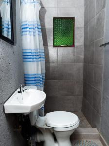 a bathroom with a toilet and a sink at Zairasbread in White River