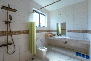 a bathroom with a toilet and a sink at Dianiluxe Villa - Spacious studio 4 in Galu +25 photos