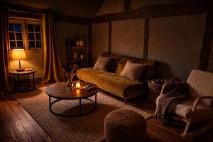 a living room with a couch and a table at Luxury Countryside Escape in Ipsden