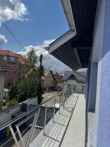 a balcony of a building with a stair railing at Casa David in Rădăuţi