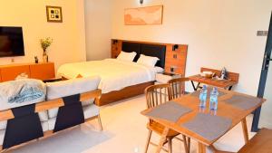 a bedroom with a bed and a table with a dining room at EZER HOMEs in Kampala