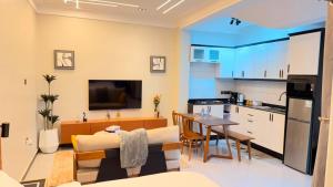 a kitchen and living room with a table and a dining room at EZER HOMEs in Kampala