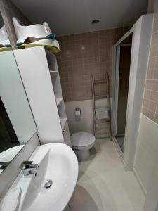 a bathroom with a white sink and a toilet at Condo with golf course views, pool and terraces in San Jorge +13 photos