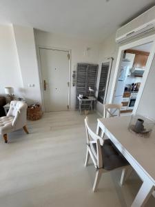 a living room with a white table and chairs at Condo with golf course views, pool and terraces in San Jorge