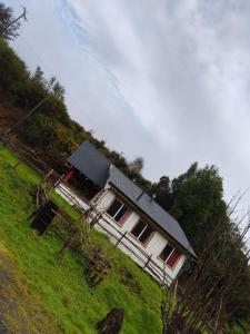 a house sitting on top of a grassy hill at Birloche in Butalcura