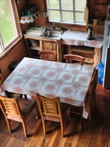a table in a kitchen with a table and chairs at Birloche in Butalcura