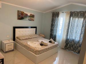 a bedroom with a bed and a window at Treeolives in Shkodër