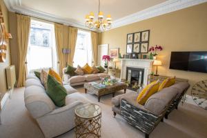 a living room with couches and a fire place at 7 Howard Place in St. Andrews