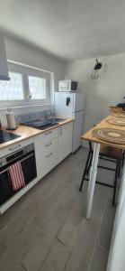 a kitchen with a table and a counter top at Chez T-E-O in Cognac +24 photos