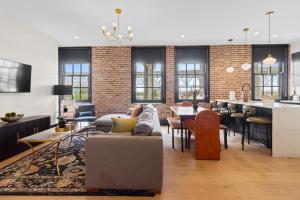 a living room with a couch and a table at Eleven48 Hotel in New Orleans