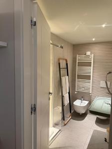 a bathroom with a shower and a sink and a toilet at Bellavitarooms-Fiore di Maggio Luxury Suites in Matera +86 photos