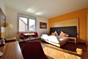 a hotel room with a bed and a table at Antonie Hotel****superior in Frýdlant