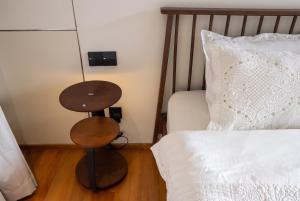 a bedroom with a table next to a bed at Qabalah Villa Private Pool & Rooftop Garden Stylish 2BR Retreat near Bang Tao in Ban Pak Lak +104 photos