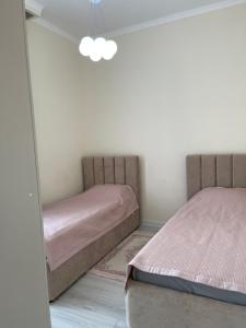 a bedroom with two beds and a mirror at Alpha White Resort in Koshkolʼ