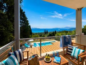 a balcony with a view of a swimming pool at Nina Apartment in Ágios Márkos +5 photos