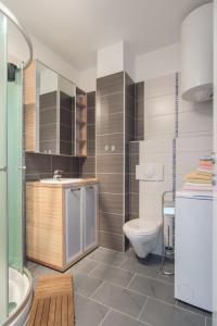 a bathroom with a toilet and a sink at Apartments Domuzin in Biograd na Moru