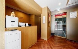 a lobby of a building with a counter and a hallway at Ryokan Hotel The Red Dragonfly in Incheon