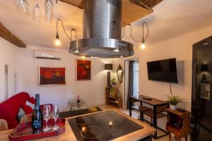 a living room with a large chandelier at Duplex Terrasse Jacuzzi Privatif & Vue Cévennes in Saint-Jean-du-Gard