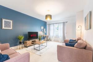 a living room with two couches and a tv at Convenient & cosy 3 bed house in Newport