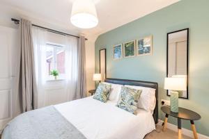 a bedroom with a bed and a table and a window at Convenient & cosy 3 bed house in Newport