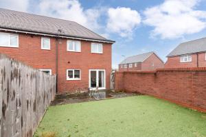 a brick house with a large yard in front of it at Convenient & cosy 3 bed house in Newport