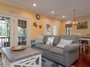 a living room with a couch and a table at 2502 Chateau by the Green in Seabrook Island