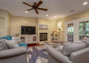 a living room with two couches and a flat screen tv at 2502 Chateau by the Green in Seabrook Island
