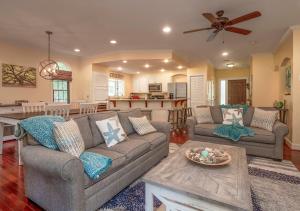 a living room with two couches and a kitchen at 2502 Chateau by the Green in Seabrook Island +30 photos