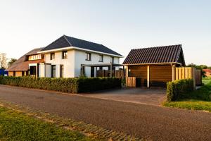 two houses on the side of a road at Luxe buitenhuis 10 pers met jacuzzi en vrij uitzicht in Rheeze