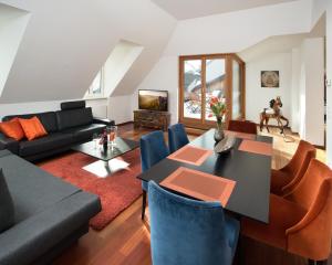 a living room with a black table and blue chairs at My Wonderland in Salzburg