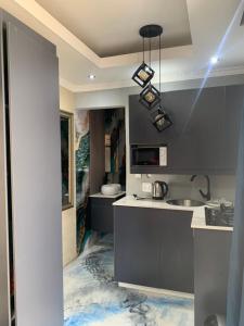 a kitchen with a sink and a microwave at Ecogreen on OR Tambo in Kempton Park