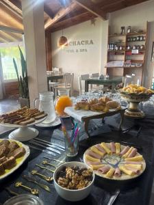 a table with many plates of food on it at La Chacra Hotel Campo y Spa in San Pedro