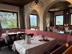 a dining room with two tables in a restaurant at Hotel Pariente in Schladming