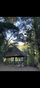a wooden gazebo in the middle of a forest at Cabañas El Nuevo Cimarrón in Puerto Varas