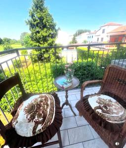 a balcony with two chairs and a table at Da Carmela Italian Home in Mantova
