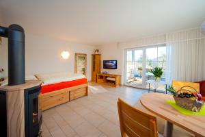 a bedroom with a bed and a table and a fireplace at Ferienwohnung Gänseblümchen in Suhl