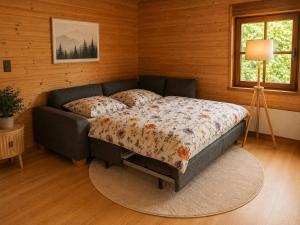 a bedroom with a bed and a couch in a room at Gerhelm 3 in Velden