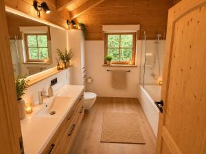 a bathroom with a white sink and a toilet at Gerhelm 3 in Velden