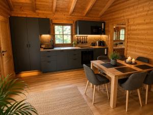 a kitchen and dining room with a table and chairs at Gerhelm 3 in Velden