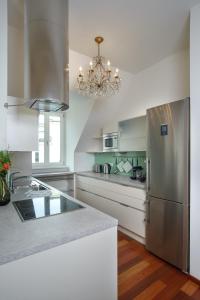 a kitchen with a stainless steel refrigerator and a chandelier at My Wonderland in Salzburg