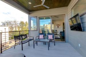 a screened in porch with chairs and a tv at Spacious Gulch Retreat Super Skyline Views in Nashville