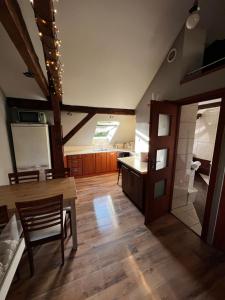 a large room with a kitchen and a dining room at Apartament przy Wyspie in Piła
