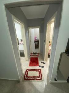 a hallway with two doors and a red rug at الملاحه in Suez