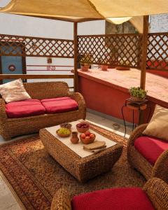 a living room with two chairs and a table at Nuragic Temple in Esterzili