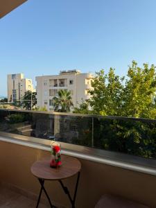 a table on a balcony with a view of a city at Vila Seaside Huqi in Durrës