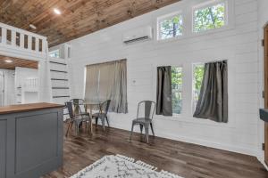 a kitchen and dining room with a table and chairs at Menlo GA Tiny Home Experience in Rising Fawn