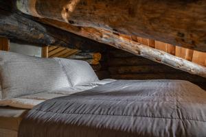 a bedroom with a bed in a log cabin at Rukan Lumikelo in Kuusamo