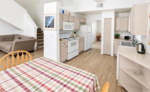 a kitchen with white appliances and a couch in a room at Villa With Private Pool, and Lake Views in Davenport