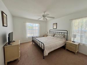 a bedroom with a bed and a ceiling fan at Villa With Private Pool, and Lake Views in Davenport +16 photos