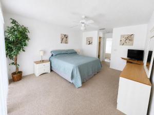a bedroom with a bed and a flat screen tv at Villa With Private Pool, and Lake Views in Davenport